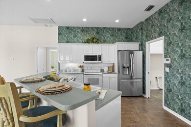 Tucked away among tree-lined streets and mature landscaping in on River Wilderness Golf and Country Club in Florida - for sale on GolfHomes.com, golf home, golf lot