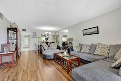 Enjoy beautiful golf course views from the large screened porch on Flamingo Lakes Country Club in Florida - for sale on GolfHomes.com, golf home, golf lot