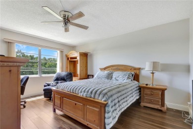 Enjoy beautiful golf course views from the large screened porch on Flamingo Lakes Country Club in Florida - for sale on GolfHomes.com, golf home, golf lot