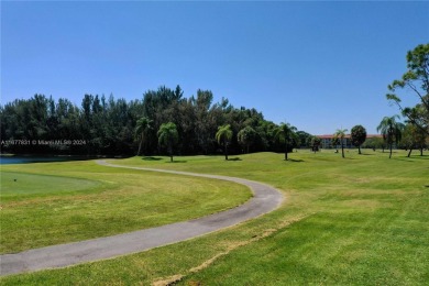 Enjoy beautiful golf course views from the large screened porch on Flamingo Lakes Country Club in Florida - for sale on GolfHomes.com, golf home, golf lot