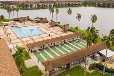 Enjoy beautiful golf course views from the large screened porch on Flamingo Lakes Country Club in Florida - for sale on GolfHomes.com, golf home, golf lot