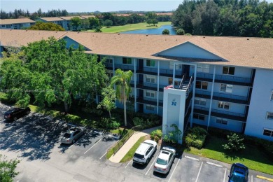 Enjoy beautiful golf course views from the large screened porch on Flamingo Lakes Country Club in Florida - for sale on GolfHomes.com, golf home, golf lot