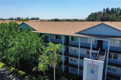Enjoy beautiful golf course views from the large screened porch on Flamingo Lakes Country Club in Florida - for sale on GolfHomes.com, golf home, golf lot