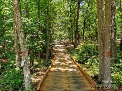 Experience refined living in this exquisite estate nestled on Old North State Club at Uwharrie Point Golf community in North Carolina - for sale on GolfHomes.com, golf home, golf lot