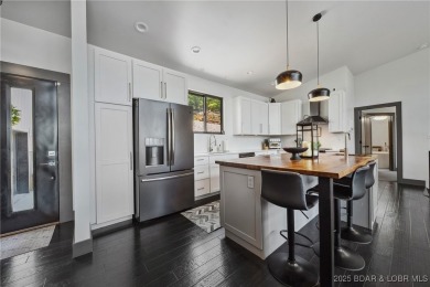 The views from this modernly constructed lakefront home are on Seasons Ridge At Four Seasons in Missouri - for sale on GolfHomes.com, golf home, golf lot