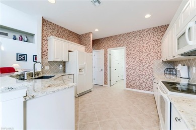 This stunning home features a spacious screened lanai with south on Shadow Wood Country Club in Florida - for sale on GolfHomes.com, golf home, golf lot