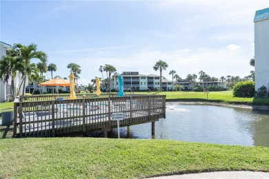 Discover your second floor haven overlooking lush greens of a on Ocean Village Golf Course in Florida - for sale on GolfHomes.com, golf home, golf lot