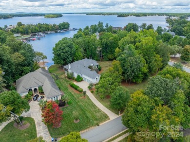 This Florida-style, hard stucco home is a beautiful ranch home on Trump National Golf Club Charlotte in North Carolina - for sale on GolfHomes.com, golf home, golf lot