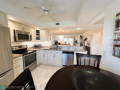 EXPANSIVE GOLF/WATER/CLUBHOUSE VIEW from this Favored LUXURY on Wynmoor Golf Course in Florida - for sale on GolfHomes.com, golf home, golf lot
