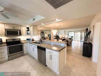 EXPANSIVE GOLF/WATER/CLUBHOUSE VIEW from this Favored LUXURY on Wynmoor Golf Course in Florida - for sale on GolfHomes.com, golf home, golf lot