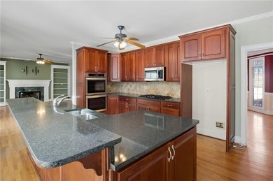 Tucked away on a quiet, double cul-de-sac street is the stately on Brookstone Golf and Country Club in Georgia - for sale on GolfHomes.com, golf home, golf lot