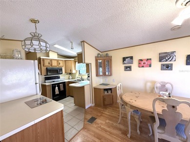 TWO BEDROOM, TWO BATHROOM MOBILE HOME IN ACTIVE 55+ COMMUNITY on River Run Golf Links in Florida - for sale on GolfHomes.com, golf home, golf lot