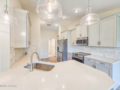 Recently purchased but never lived in! This beautiful 3-bedroom on The Grand Club - Pine Lakes Course in Florida - for sale on GolfHomes.com, golf home, golf lot