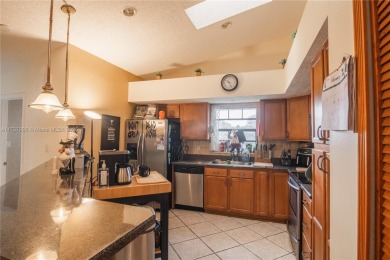This charming two-bedroom, two-bathroom townhouse offers a on Woodmont Country Club in Florida - for sale on GolfHomes.com, golf home, golf lot
