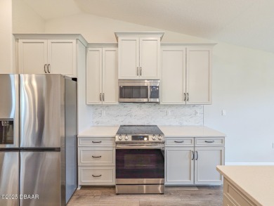 Recently purchased but never lived in! This beautiful 3-bedroom on The Grand Club - Pine Lakes Course in Florida - for sale on GolfHomes.com, golf home, golf lot