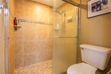 This charming two-bedroom, two-bathroom townhouse offers a on Woodmont Country Club in Florida - for sale on GolfHomes.com, golf home, golf lot