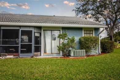This charming two-bedroom, two-bathroom townhouse offers a on Woodmont Country Club in Florida - for sale on GolfHomes.com, golf home, golf lot