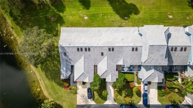 This charming two-bedroom, two-bathroom townhouse offers a on Woodmont Country Club in Florida - for sale on GolfHomes.com, golf home, golf lot