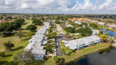 This charming two-bedroom, two-bathroom townhouse offers a on Woodmont Country Club in Florida - for sale on GolfHomes.com, golf home, golf lot