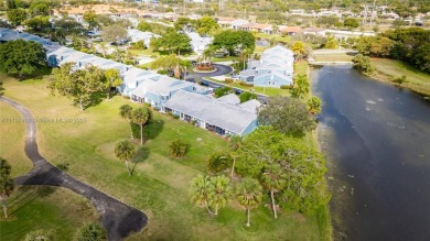 This charming two-bedroom, two-bathroom townhouse offers a on Woodmont Country Club in Florida - for sale on GolfHomes.com, golf home, golf lot