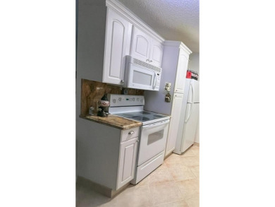 RENOVATED FRESH PAINT EXPANSIVE WATER VIEW WALK TO HOUSES OF on Hillsboro Pines Golf in Florida - for sale on GolfHomes.com, golf home, golf lot