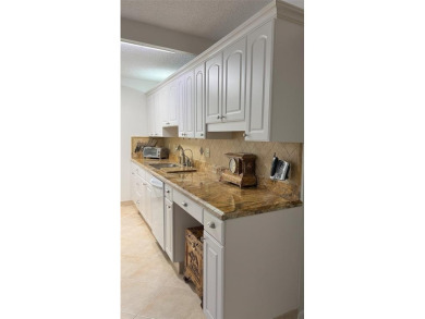 RENOVATED FRESH PAINT EXPANSIVE WATER VIEW WALK TO HOUSES OF on Hillsboro Pines Golf in Florida - for sale on GolfHomes.com, golf home, golf lot