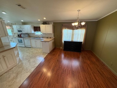 Centrally located, welcome to your new home in beautiful Winter on Lake Henry Golf Club in Florida - for sale on GolfHomes.com, golf home, golf lot