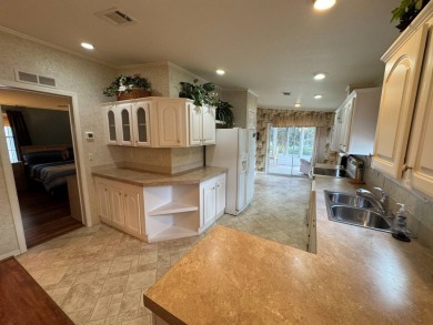 Centrally located, welcome to your new home in beautiful Winter on Lake Henry Golf Club in Florida - for sale on GolfHomes.com, golf home, golf lot