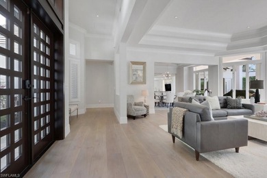 Experience elevated coastal living in this stunning Pelican Bay on Club at Pelican Bay Golf Course in Florida - for sale on GolfHomes.com, golf home, golf lot