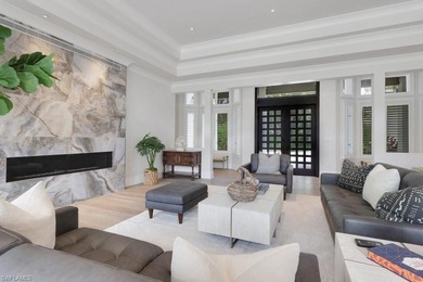 Experience elevated coastal living in this stunning Pelican Bay on Club at Pelican Bay Golf Course in Florida - for sale on GolfHomes.com, golf home, golf lot