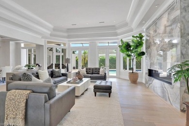 Experience elevated coastal living in this stunning Pelican Bay on Club at Pelican Bay Golf Course in Florida - for sale on GolfHomes.com, golf home, golf lot