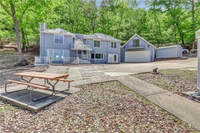 Discover this waterfront retreat with easy walkout to shoreline on Seasons Ridge At Four Seasons in Missouri - for sale on GolfHomes.com, golf home, golf lot
