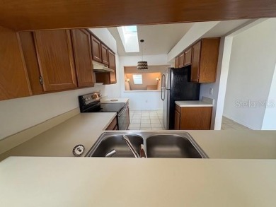 Light and bright 3BED/2BA Condominium with attached garage on East Lake Woodlands Country Club in Florida - for sale on GolfHomes.com, golf home, golf lot