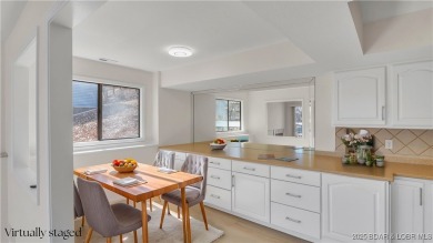 Discover this waterfront retreat with easy walkout to shoreline on Seasons Ridge At Four Seasons in Missouri - for sale on GolfHomes.com, golf home, golf lot