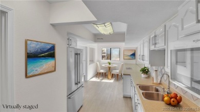Discover this waterfront retreat with easy walkout to shoreline on Seasons Ridge At Four Seasons in Missouri - for sale on GolfHomes.com, golf home, golf lot