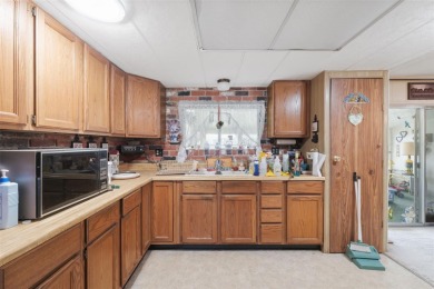 This 2 bedroom, 2 bath home with a covered carport wraps you in on High Point Golf Club, Inc. in Florida - for sale on GolfHomes.com, golf home, golf lot