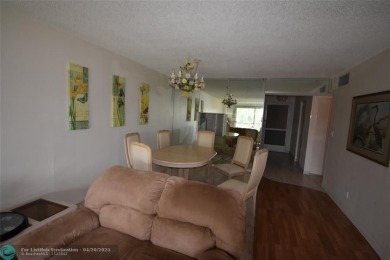 Discover convenience, and scenic beauty in this lovely 2-bedroom on Inverrary Country Club in Florida - for sale on GolfHomes.com, golf home, golf lot