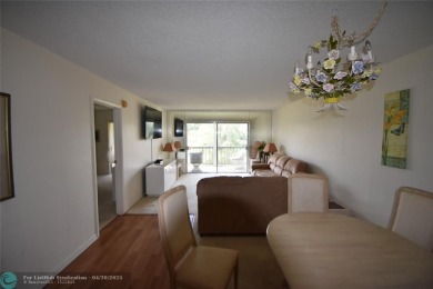 Discover convenience, and scenic beauty in this lovely 2-bedroom on Inverrary Country Club in Florida - for sale on GolfHomes.com, golf home, golf lot