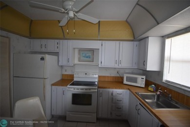 Discover convenience, and scenic beauty in this lovely 2-bedroom on Inverrary Country Club in Florida - for sale on GolfHomes.com, golf home, golf lot