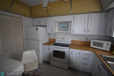 Discover convenience, and scenic beauty in this lovely 2-bedroom on Inverrary Country Club in Florida - for sale on GolfHomes.com, golf home, golf lot