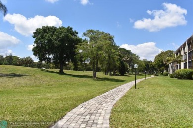 Discover convenience, and scenic beauty in this lovely 2-bedroom on Inverrary Country Club in Florida - for sale on GolfHomes.com, golf home, golf lot