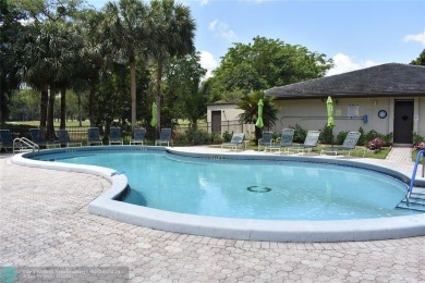 Discover convenience, and scenic beauty in this lovely 2-bedroom on Inverrary Country Club in Florida - for sale on GolfHomes.com, golf home, golf lot
