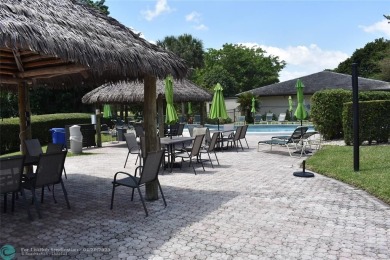 Discover convenience, and scenic beauty in this lovely 2-bedroom on Inverrary Country Club in Florida - for sale on GolfHomes.com, golf home, golf lot