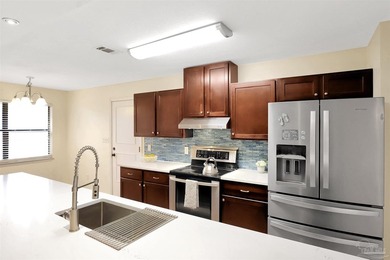 Located in the heart of Tiger Point, this 4-bedroom, 2-bath home on Tiger Point Golf and Country Club in Florida - for sale on GolfHomes.com, golf home, golf lot