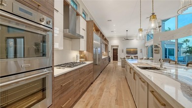 Situated within the gated Queens Harbour enclave of Bay Isles on Longboat Key Golf Club Resort in Florida - for sale on GolfHomes.com, golf home, golf lot