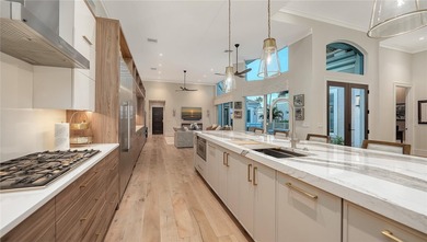 Situated within the gated Queens Harbour enclave of Bay Isles on Longboat Key Golf Club Resort in Florida - for sale on GolfHomes.com, golf home, golf lot