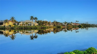 Situated within the gated Queens Harbour enclave of Bay Isles on Longboat Key Golf Club Resort in Florida - for sale on GolfHomes.com, golf home, golf lot