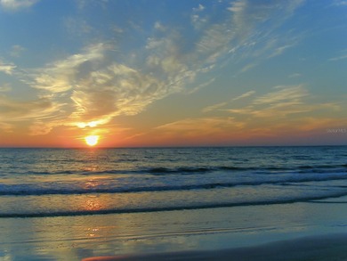 Situated within the gated Queens Harbour enclave of Bay Isles on Longboat Key Golf Club Resort in Florida - for sale on GolfHomes.com, golf home, golf lot