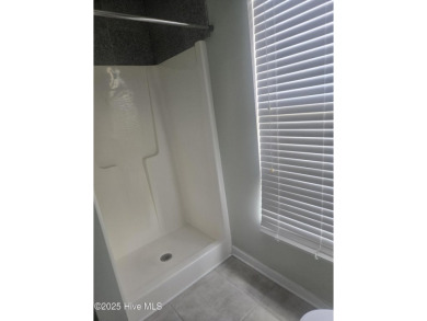 A beach getaway with three bedrooms PLUS an income producing on Sea Trail Golf Resort in North Carolina - for sale on GolfHomes.com, golf home, golf lot