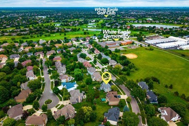 Welcome to this exquisite home nestled down a tree-lined street on White Eagle Golf Club in Illinois - for sale on GolfHomes.com, golf home, golf lot